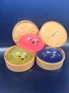 Three colorful Mystery Dumpling sensory toys revealed in dumpling baskets