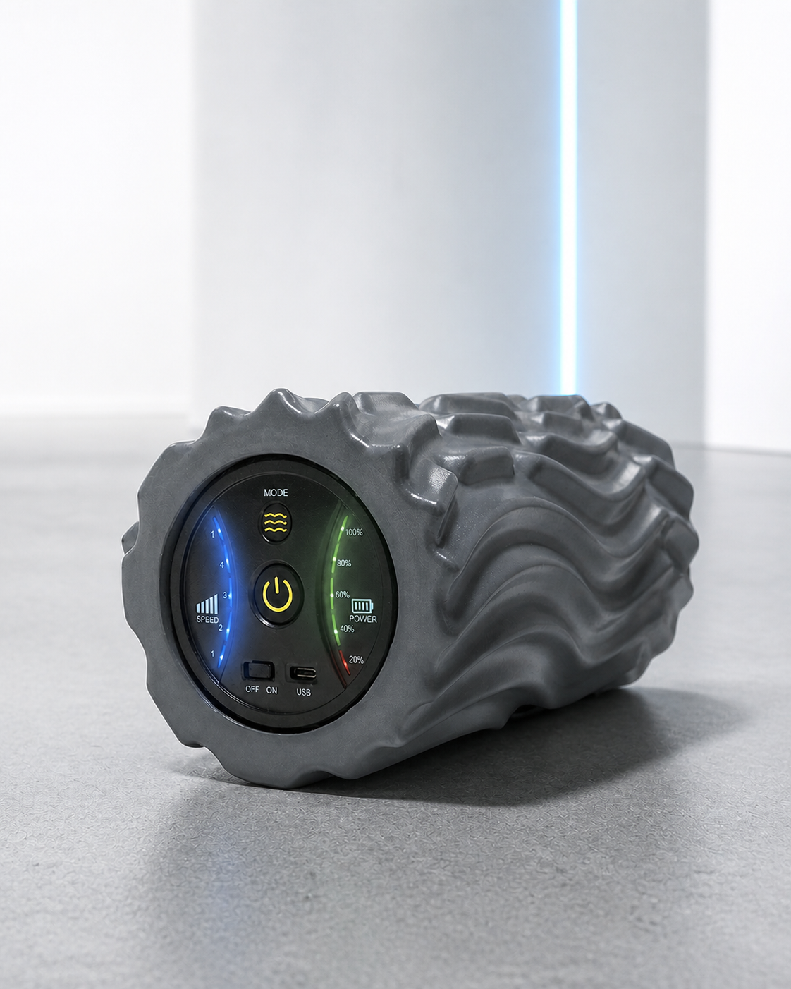 Space-gray vibrating foam roller in a bright athletic studio
